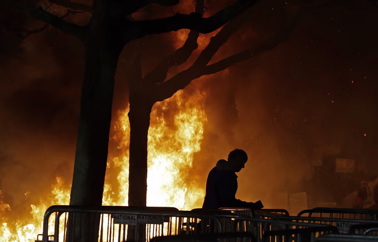 Image: A bonfire set by demonstrators protesting a scheduled speaking appearance by Breitbart News editor Milo Yiannopoulos burns on Sproul Plaza on the University of California at Berkeley campus on Wednesday, Feb. 1, 2017, in Berkeley, Calif.