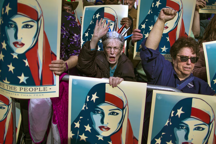 Image: People carry posters during the rally against President Trump's executive order banning travel from seven Muslim-majority nations, in Times Square, Feb. 19, 2017.