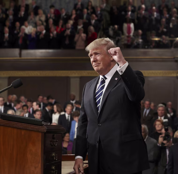 Image: US President Donald J. Trump arrives to deliver his first address to a joint session of Congress from the floor of the House of Representatives in Washington