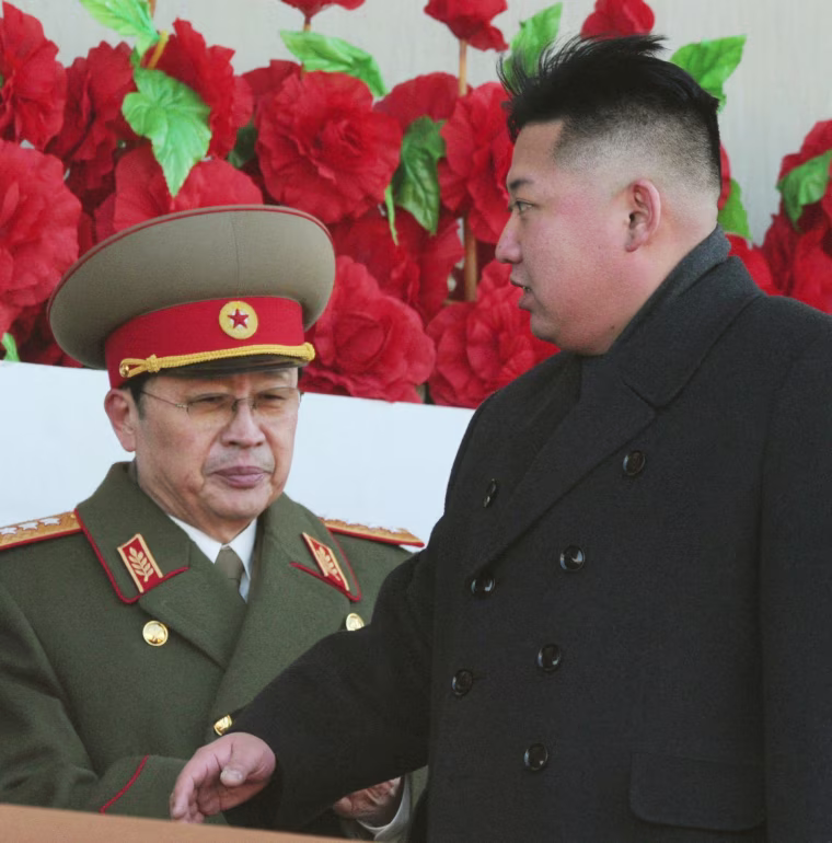 Image: North Korean leader Kim Jong-un walks past his uncle, North Korean politician Jang Song Thaek, during a military parade in Pyongyang on Feb. 16, 2012.