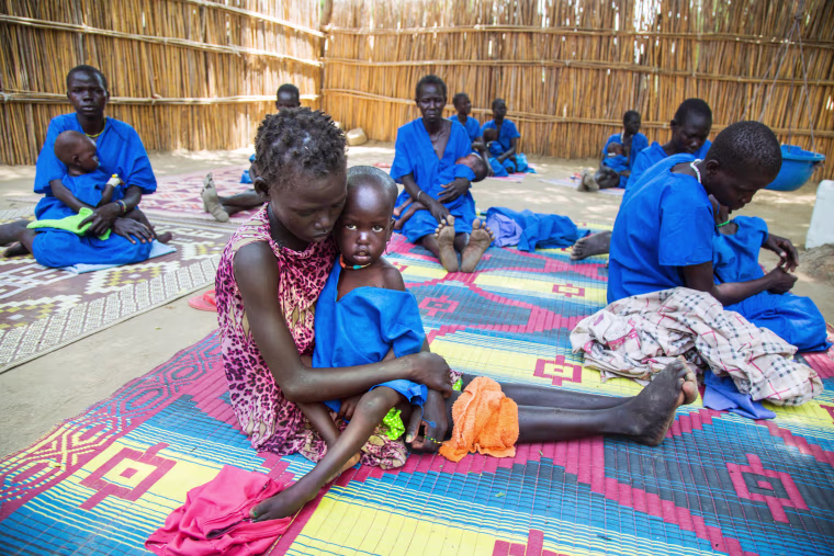 Image: Moms hold malnourished children in South Sudan