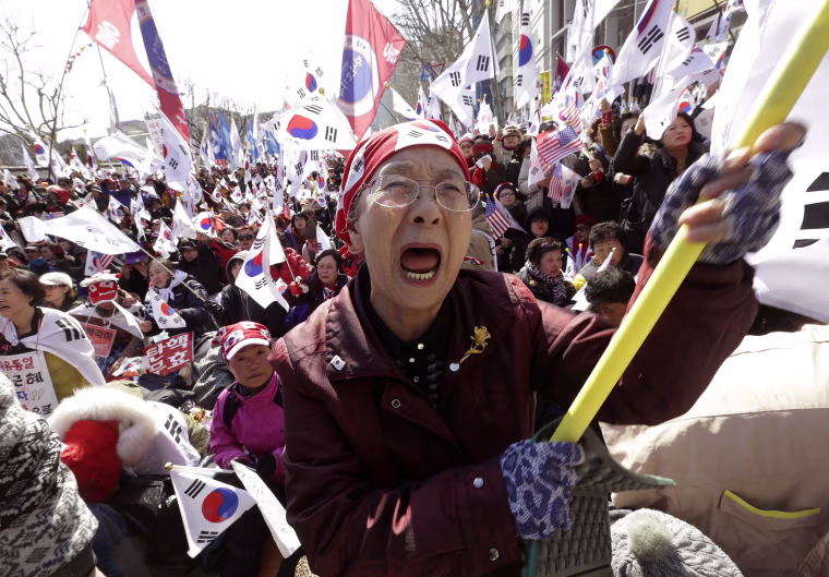 Image: A supporter of the South Korean president cries during a rally opposing her impeachment.