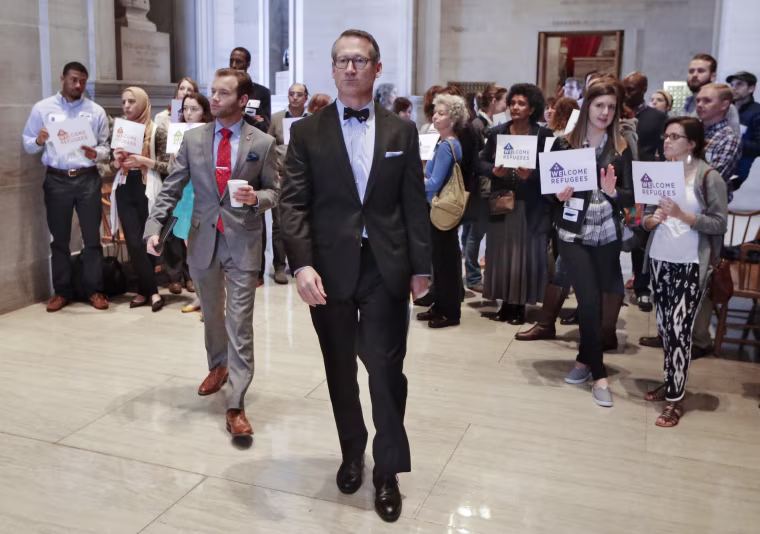 Image: Sen. Bo Watson, center, R-Hixson, walks past demonstrators opposed to immigration restrictions