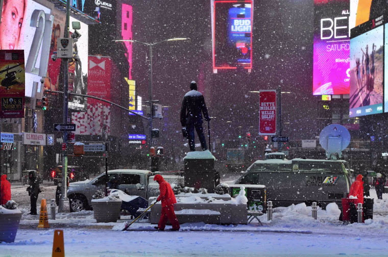 Image: Men plow snow in Times Square