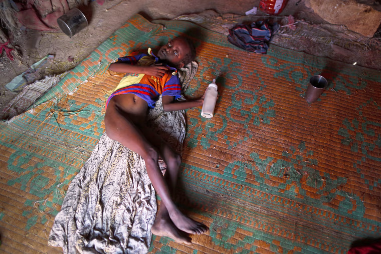 Image: A malnourished young internally displaced person with a mental disability lays inside his family's shelter in a camp on the outskirts of Qardho, in Somalia's semi-autonomous region of Puntland, March 26.
