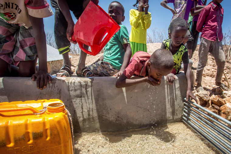 Image: Children drink water delivered by a truck in the drought-stricken Baligubadle village in this handout provided by The International Federation of Red Cross and Red Crescent Societies on March 15.