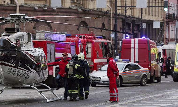 Image: General view of emergency services attending the scene outside Sennaya Ploshchad metro station, following explosions in two train carriages in St. Petersburg