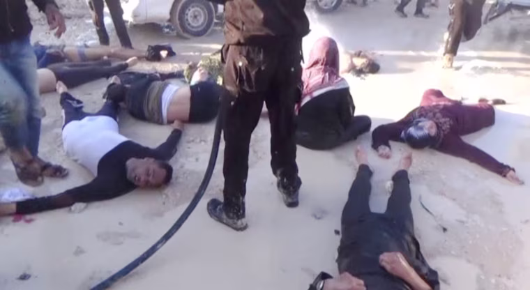 Image: A still image taken from a video posted to a social media website on April 4, 2017, shows people lying on the ground, said to be in the town of Khan Sheikhoun, after what rescue workers described as a suspected gas attack in rebel-held Idlib