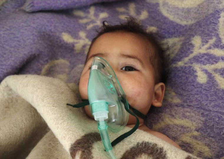 Image: A Syrian child receives treatment at a small hospital in the town of Maaret al-Noman