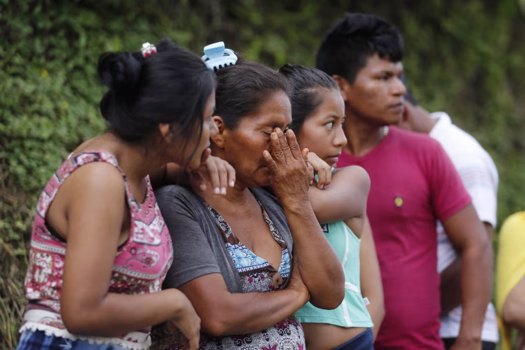 Image: People line up outside a cemetery to looking for their missing relatives in Mocoa