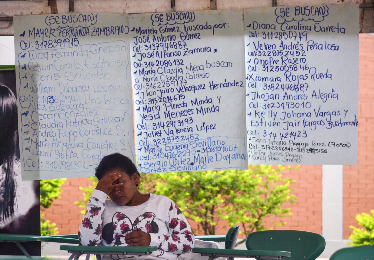 Image: A woman waits for news of her missing relatives at a shelter in Mocoa