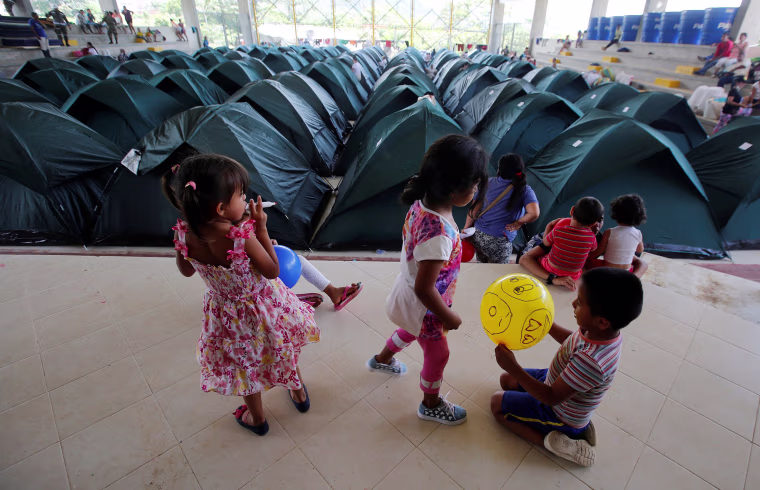 Image: Children play in a shelter for people who became homeless after flooding and mudslides caused by heavy rains leading several rivers to overflow, pushing sediment and rocks into buildings and roads in Mocoa