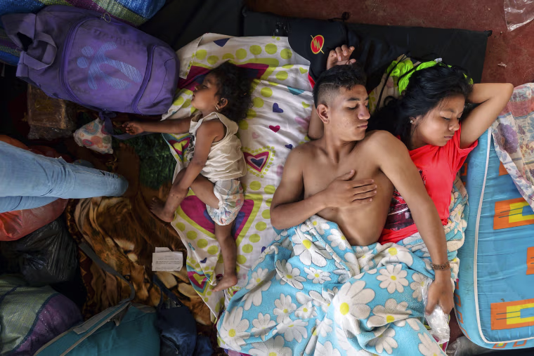 Image: A family rests at a shelter in Mocoa