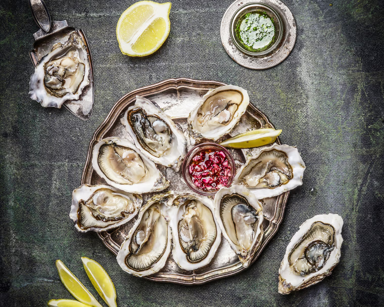 Oysters plate with lemon and sauces , top view