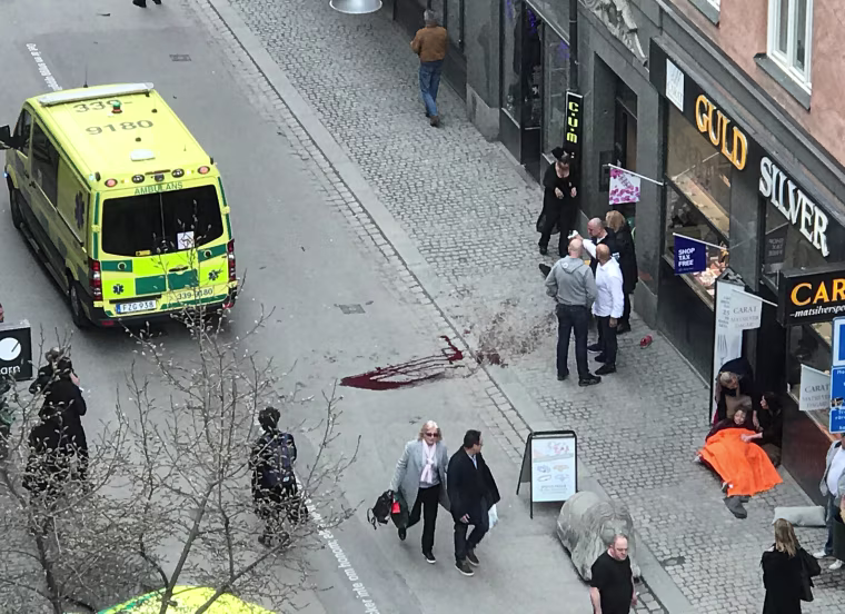 Image: Ambulance in a street near the site were a truck was driving into a crowd in central Stockholm