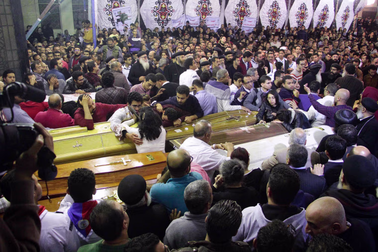 Image: Egyptians gather to mourn late into the night in Tanta, April 9.