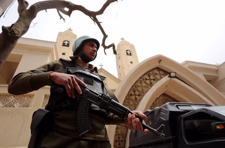 Image: An armed policeman secures the Coptic church that was bombed on Palm Sunday in Tanta, April 10.