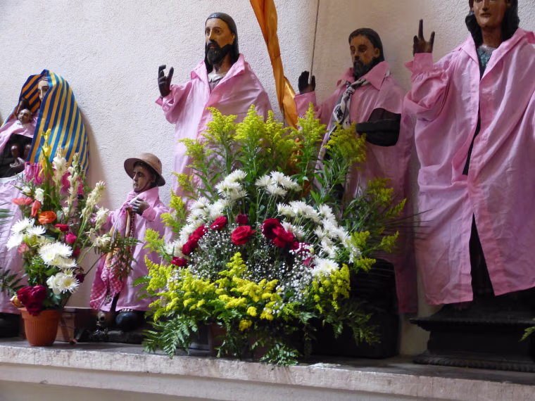 Statues of saints Inside the Church of Santiago Apostol in Santiago Atitlan are dressed in colorful clothing reminiscent of the dress of indigenous townsfolk. Flowers symbolize life and resurrection.