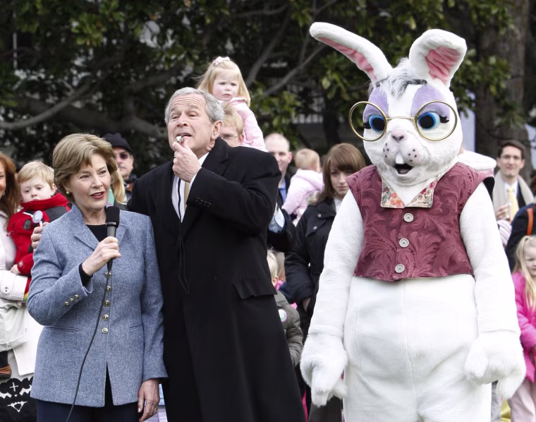 Image: U.S. President Bush blows a whistle to start the annual Easter Egg Roll in Washington