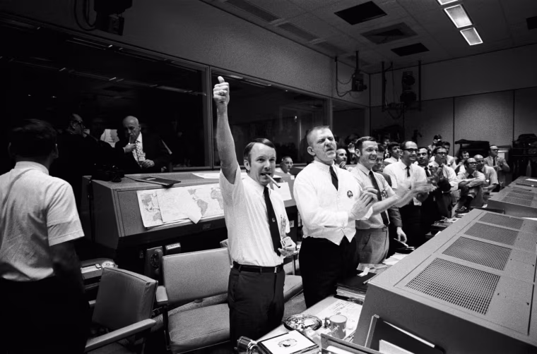 Three of the four Apollo 13 Flight Directors applaud the successful splashdown of the Command Module 'Odyssey' while Dr. Robert R. Gilruth, Director, Manned Spacecraft Center (MSC), and Dr. Christopher C. Kraft Jr., MSC Deputy Director, light up cigars (upper left). The Flight Directors are from left to right: Gerald D. Griffin, Eugene F. Kranz and Glynn S. Lunney - April 17, 1970 (Photo by NASA/ullstein bild via Getty Images)