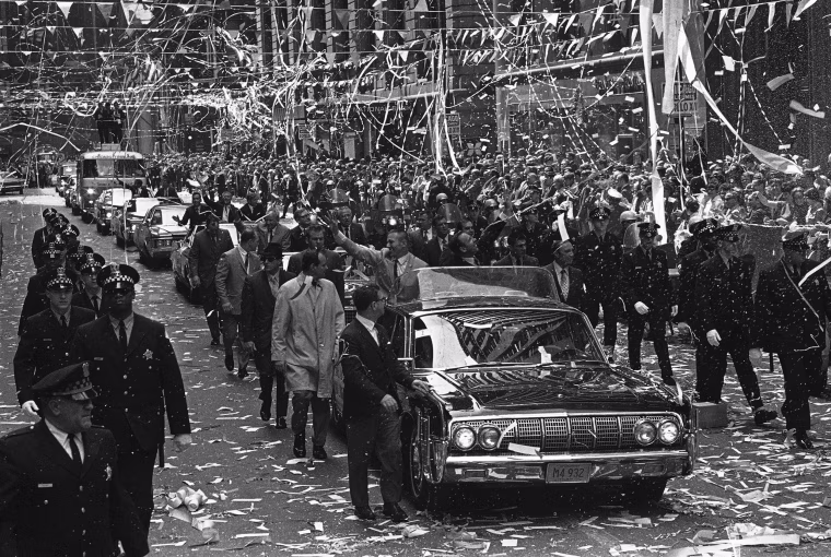 Confetti pours from the skyscrapers in Chicago?s financial district, May 1, 1970 as Apollo 13 astronauts John Swigert Jr., waving left, and James Lovell ride in a motorcade during a parade in their honor. (AP Photo)