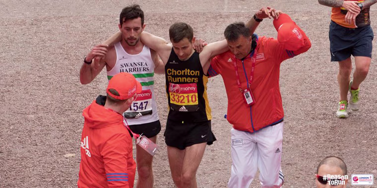 Image: London Marathon runner Matt Rees helps fellow participant David Wyeth to cross the finish line, April 23, 2017.