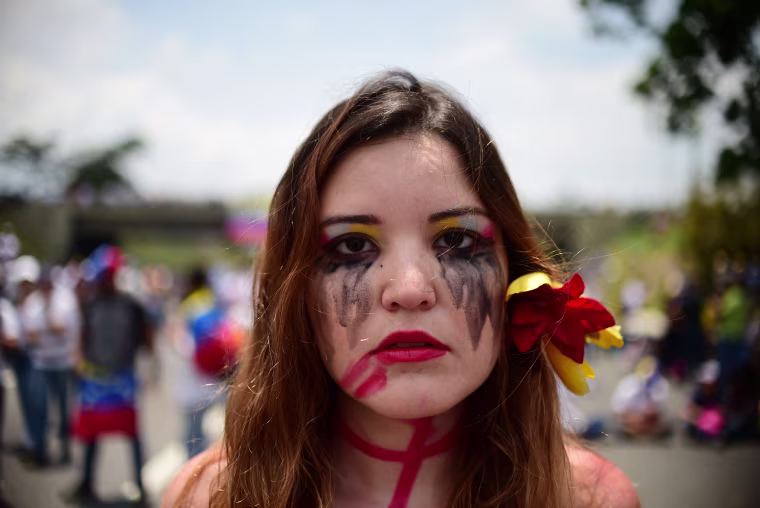 Image: An opposition activist participates in a sit-in in Caracas