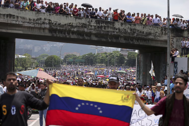 Image: Anti-government protesters block a highway in Caracas