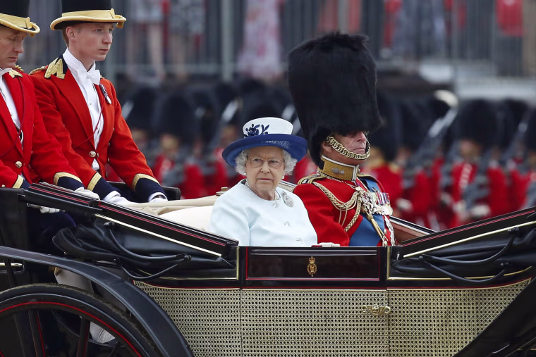 Image: Britain's Queen Elizabeth and Prince Philip leave the annual Trooping the Colour ceremony at Horse Guards Parade in central London