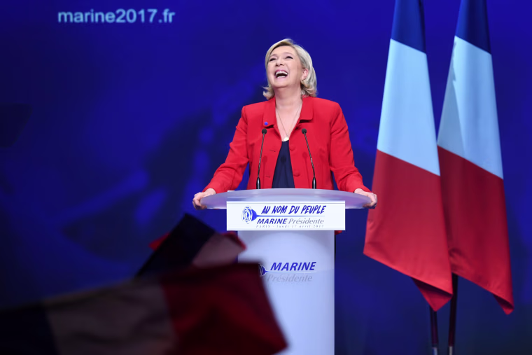 Image: Marine Le Pen reacts on stage during a campaign meeting in Paris