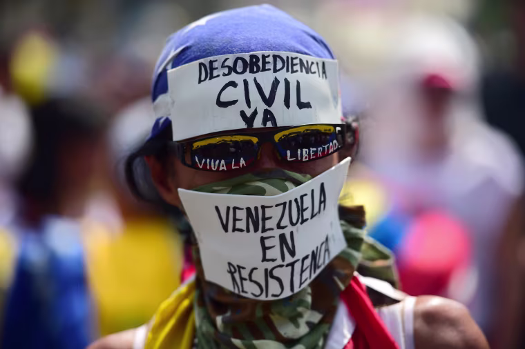 Image: A demonstrator calls for civil disobedience during a protest at the east side of Caracas on April 19, 2017.