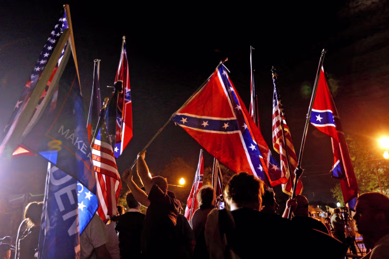 Image: Protesters gather before a monument of Jefferson Davis is removed in New Orleans