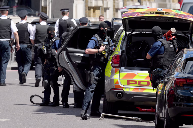 Image: Armed police officers return to their vehicles as Prime Minister Theresa May calls a meeting of the emergency response committee, Cobra.