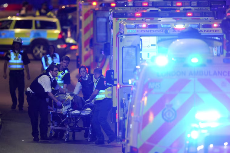 Image: Police officers and members of the emergency services attend to injured people.