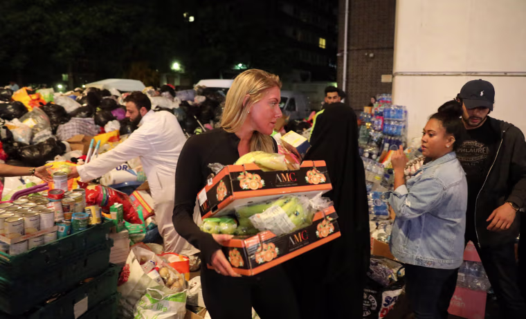 Image: Volunteers help with food deliveries after the Grenfell Tower fire in London
