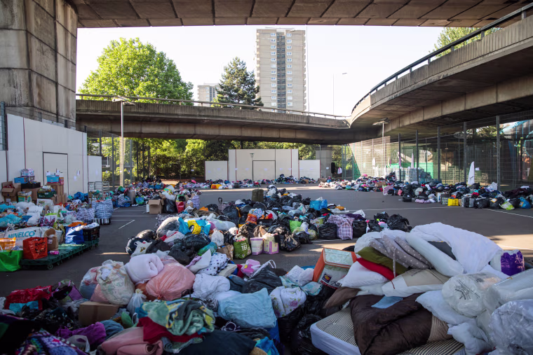 Image: Donations of clothing piled up at the Westway Sports Centre