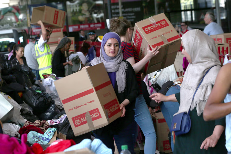 Image: Clothing and other supplies are stored near a tower block which was destroyed in a fire disaster in West London