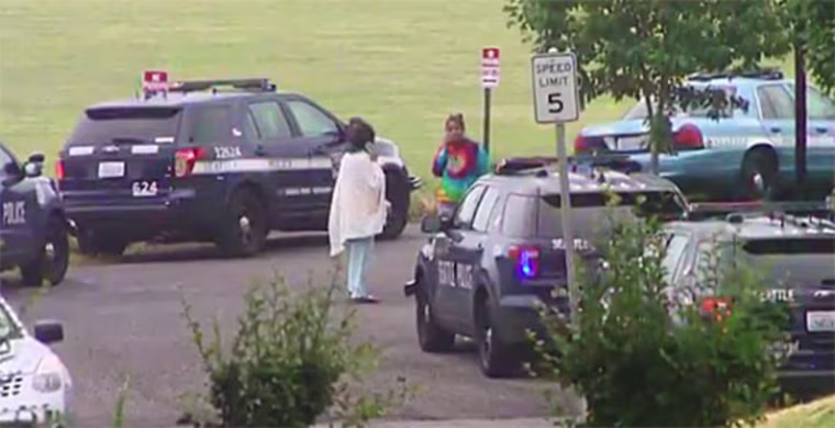 Seattle police respond at the scene where police earlier shot and killed a woman while responding to a burglary call.