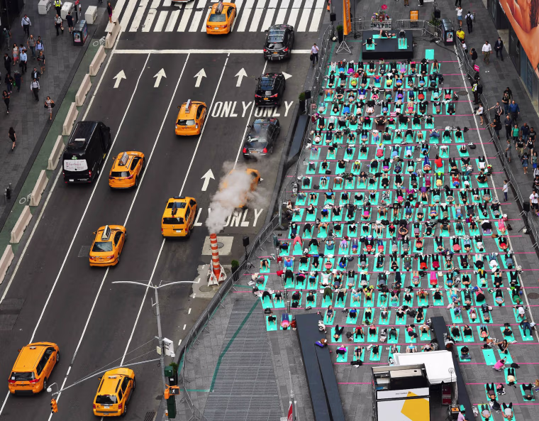 Image: People practice yoga in Times Square