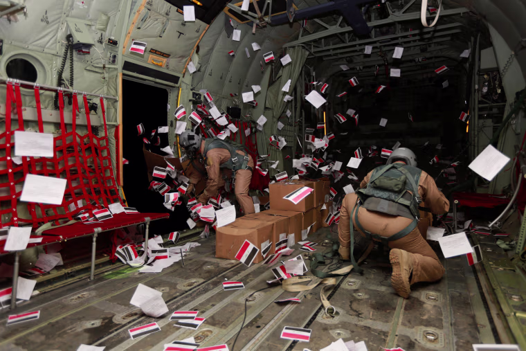 Image: Iraqi Army personnel drop leaflets over Iraq