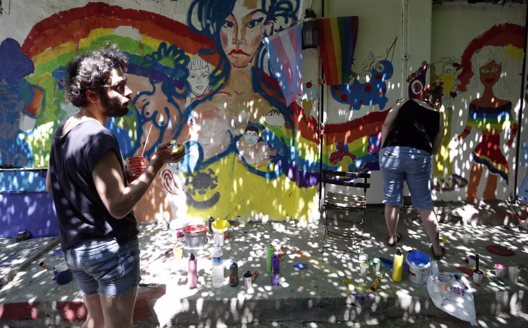 Image: People paint walls with the colors of the rainbow during LGBT Pride Week in Istanbul