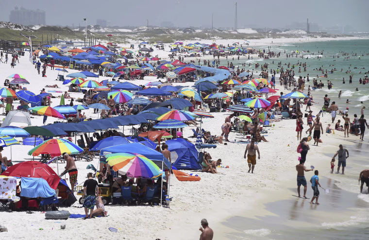 Image: People crowd the beach on Okaloosa Island in Fort Walton Beach