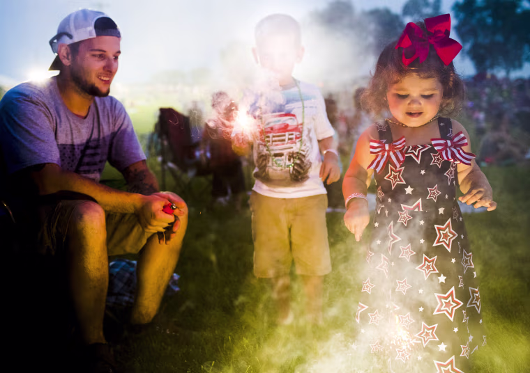 Image: Ashlynn Zinman, 2, from right, plays with sparklers with her brother, Carson Zinman, 5, and father Anthony Zinman,
