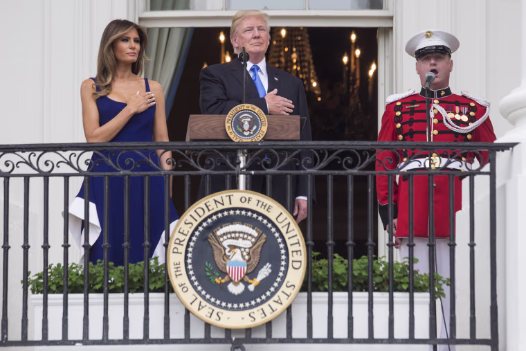 Image: President Trump and first lady Melania Trump observe the playing of the national anthem from the Truman Balcony