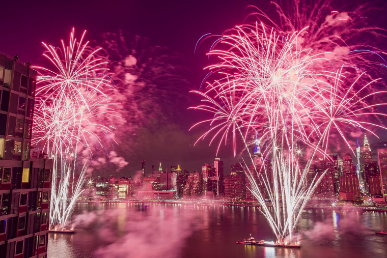 Image: With the New York City skyline in the background, fireworks explode during an Independence Day show over the East River in New York