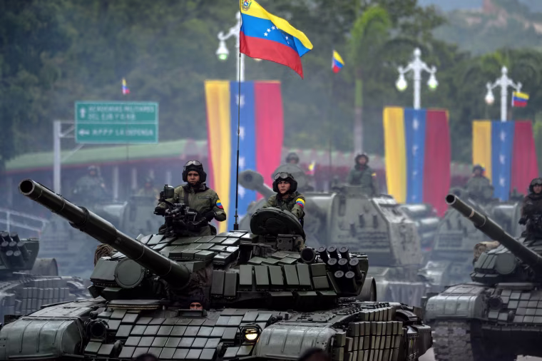 Image: Venezuelan Russian-made Mi-17 helicopters overfly a column of T-72B tanks during a military parade