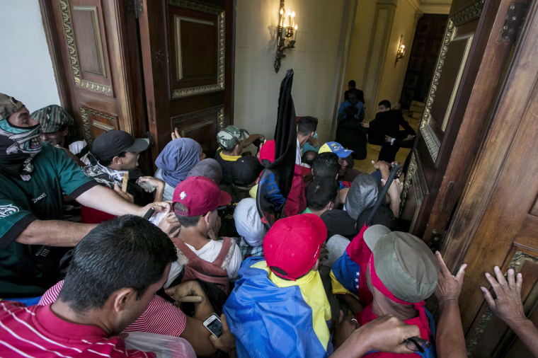 Image: Government supporters break into Venezuelan Parliament and wound deputies
