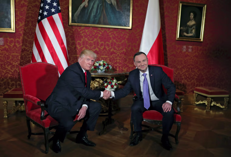 Image: U.S. President Donald Trump shakes hands with Polish President Andrzej Duda in Warsaw