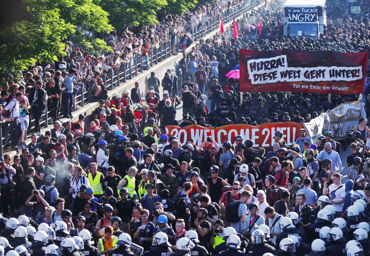 Image: Protesters hold placards during the demonstration during the G20 summit in Hamburg