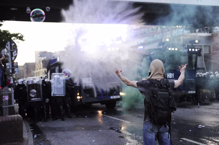 Image: Riot police use water cannon during the \"Welcome to Hell\" rally